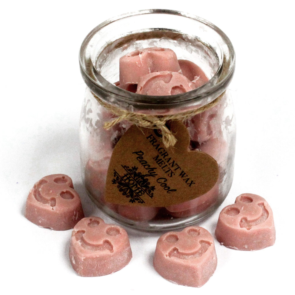 Jar of pink wax melts with a heart-shaped tag on a white background