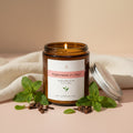 Jar of peppermint and clove candle on a light background
