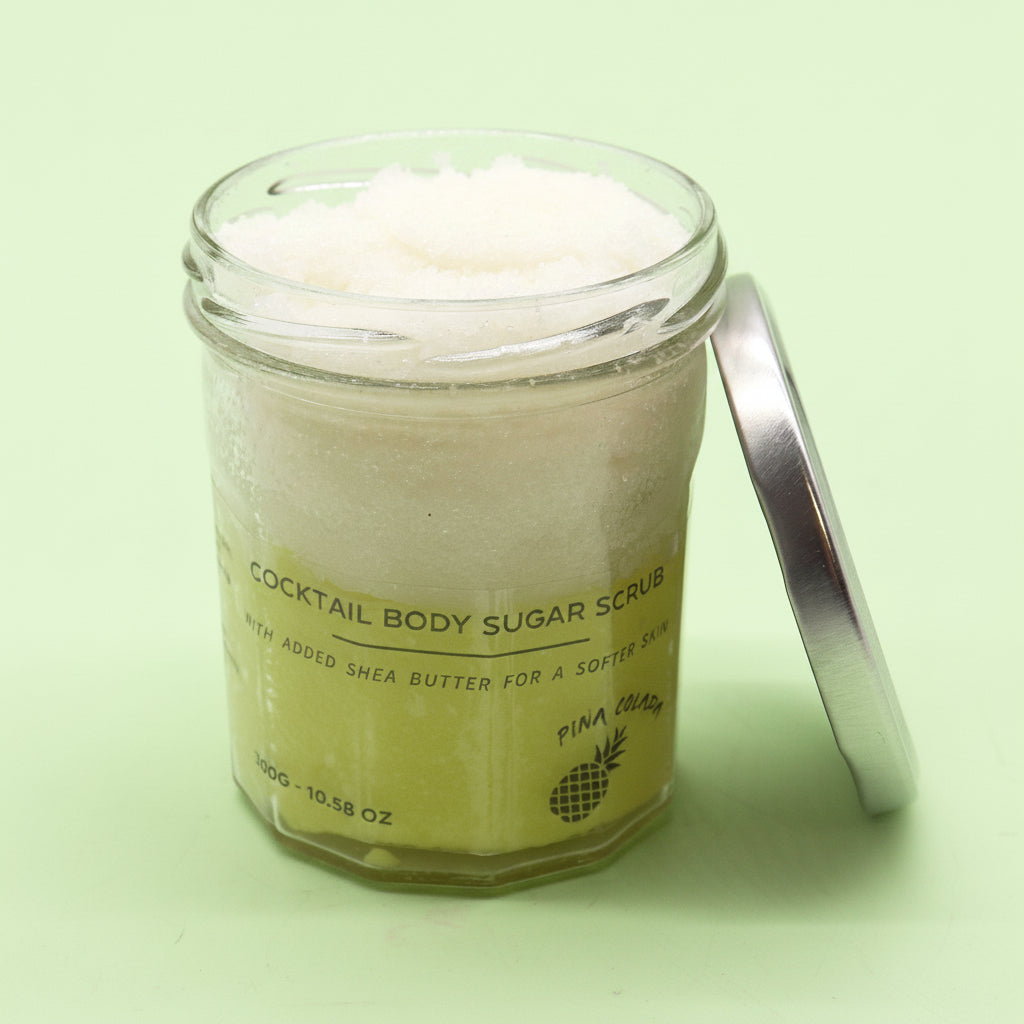 white and green body scrub in glass jar
