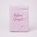 Pink fuzzy notebook with 'before I forget...' text on a pink background