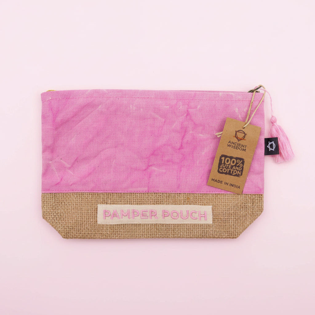 Pink and jute pouch with 'Pamper Pouch' label and tag on a pink background