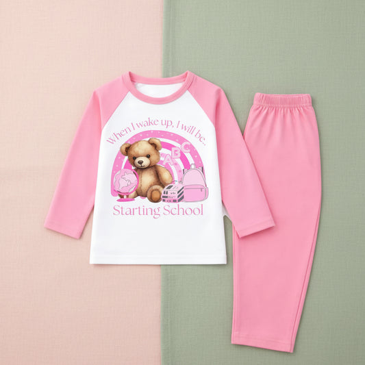 Pink pajama set with a teddy bear graphic and text on a blush and sage background