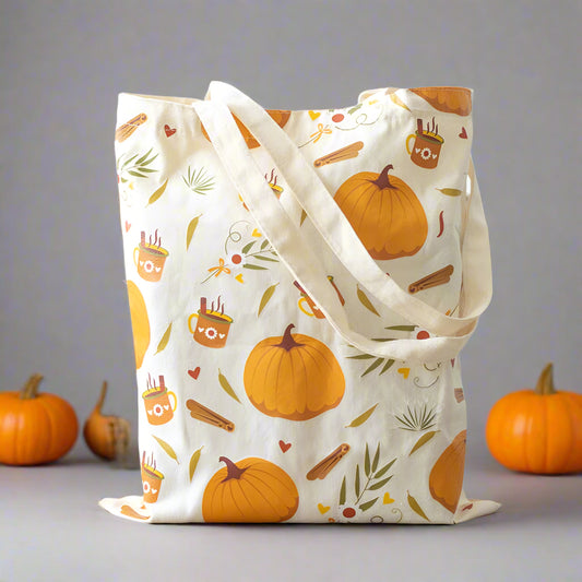 Tote bag with autumn-themed design featuring pumpkins and leaves 