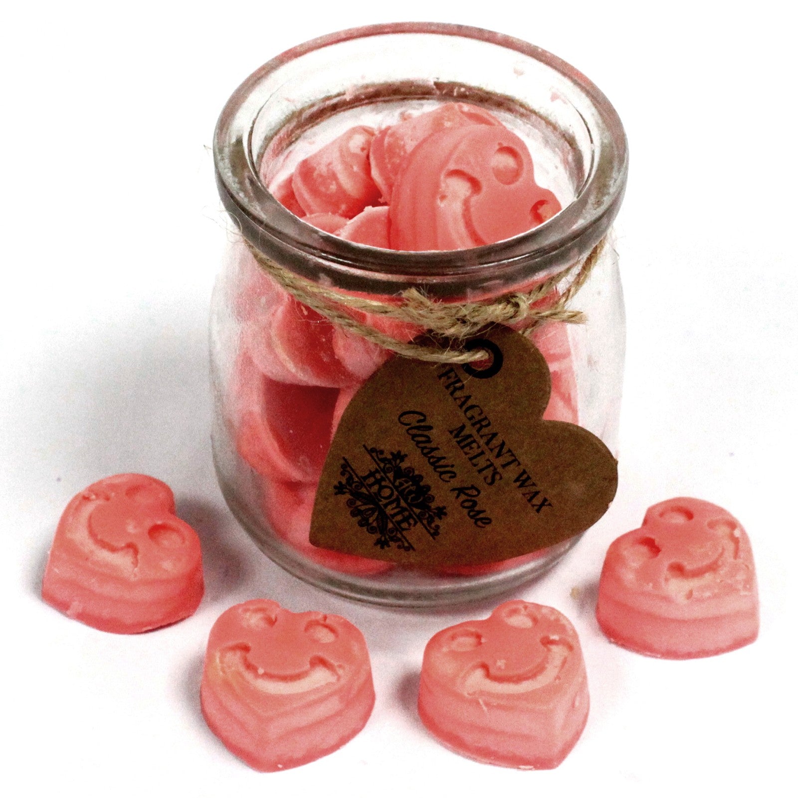 Pink heart-shaped wax melts in a glass jar with a heart-shaped label on a white background