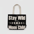 Black tote bag with 'Stay Wild Moon Child' text and moon phases on a white background