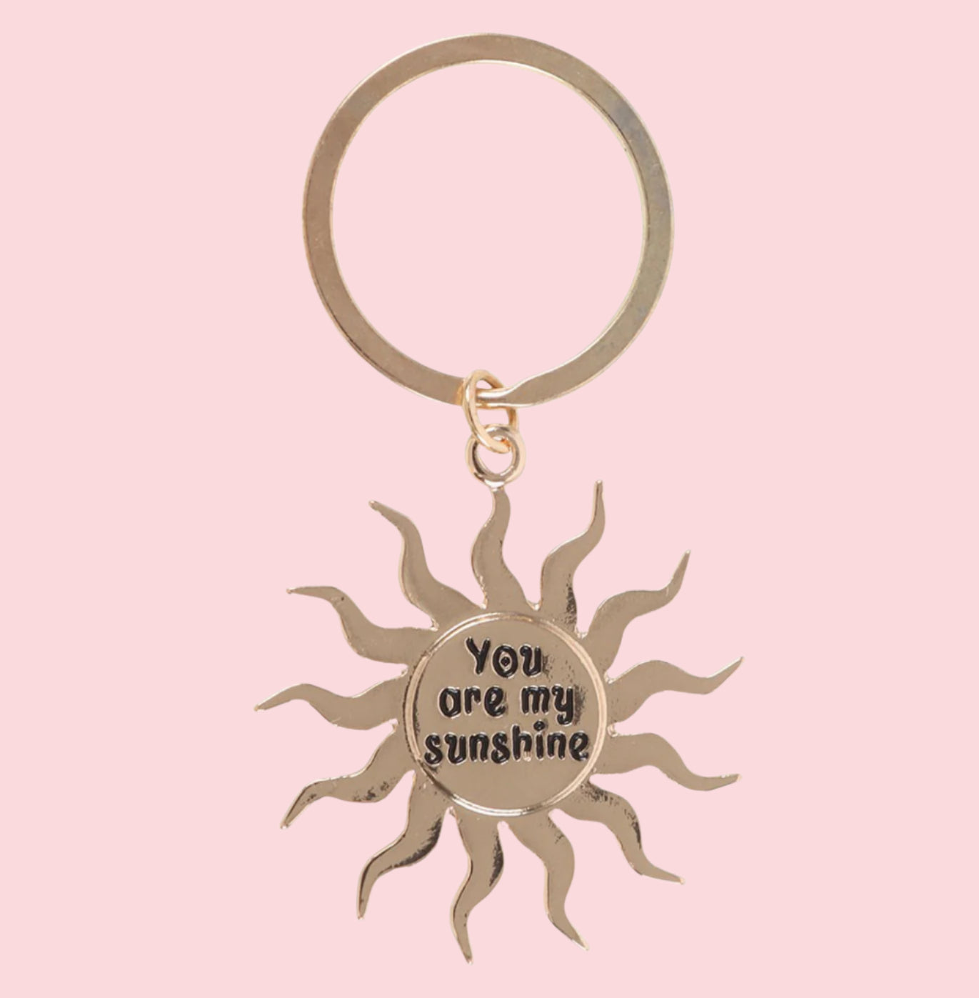 Sun-shaped keychain with 'You are my sunshine' text on a pink background