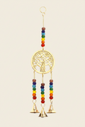 Decorative hanging with tree of life design and rainbow beads and bells on a beige background