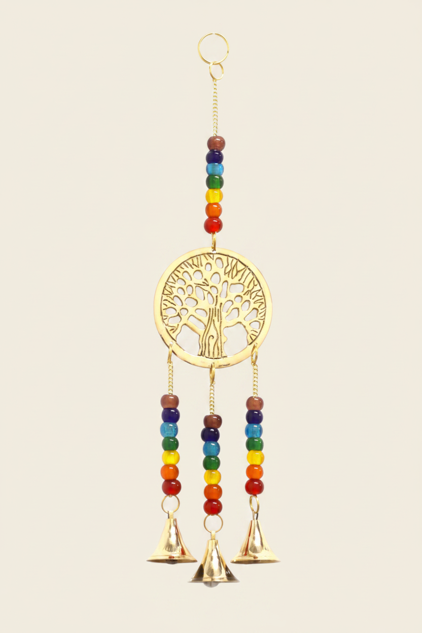 Decorative hanging with tree of life design and rainbow beads and bells on a beige background