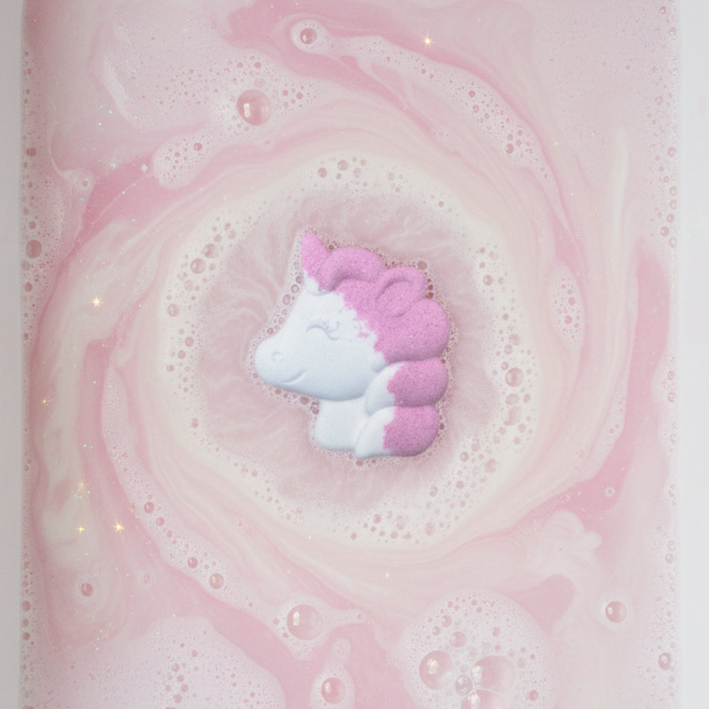 Unicorn-shaped bath bomb with pink and white colors on a water background