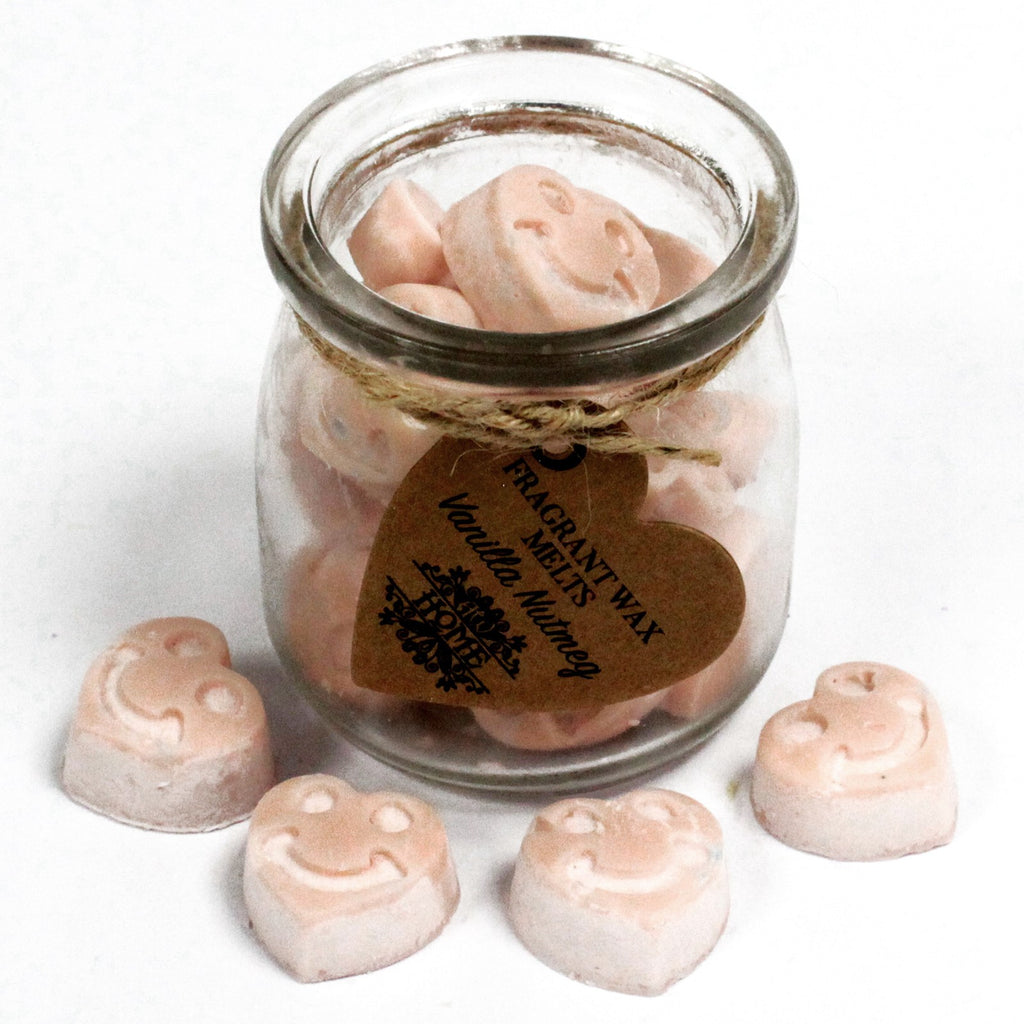 Glass jar with heart-shaped wax melts and a label on a white background