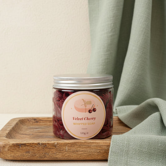 Jar of Velvet Cherry whipped soap on a pink background