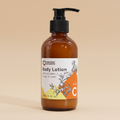 Brown bottle of body lotion with a label on a orange background