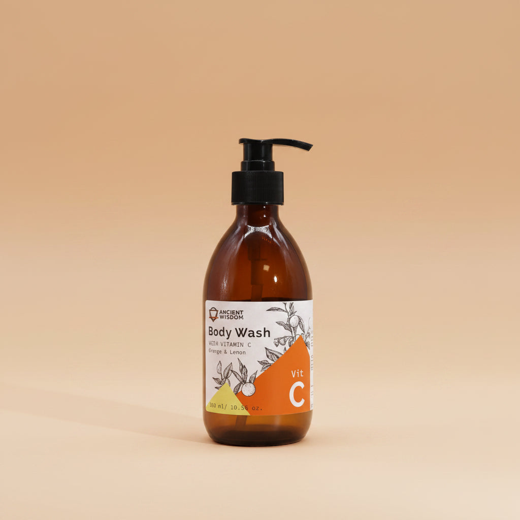 Brown bottle of body wash with a pump and label on a orange background