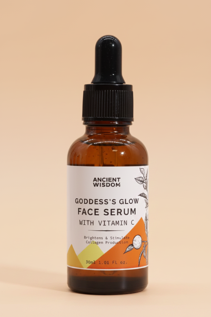 Bottle of Goddess's Glow Face Serum with Vitamin C on a orange  background