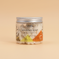 Jar of whipped soap with vitamin C from Ancient Wisdom on a orange background