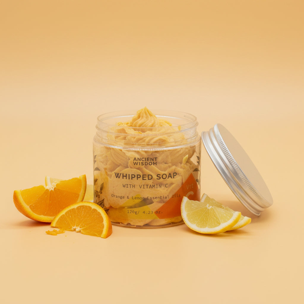 Jar of whipped soap with a silver lid on a light orange background