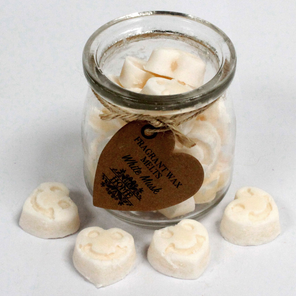 Jar of heart-shaped wax melts with a brown label on a white background