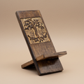 Wooden phone stand with tree design on a brown background