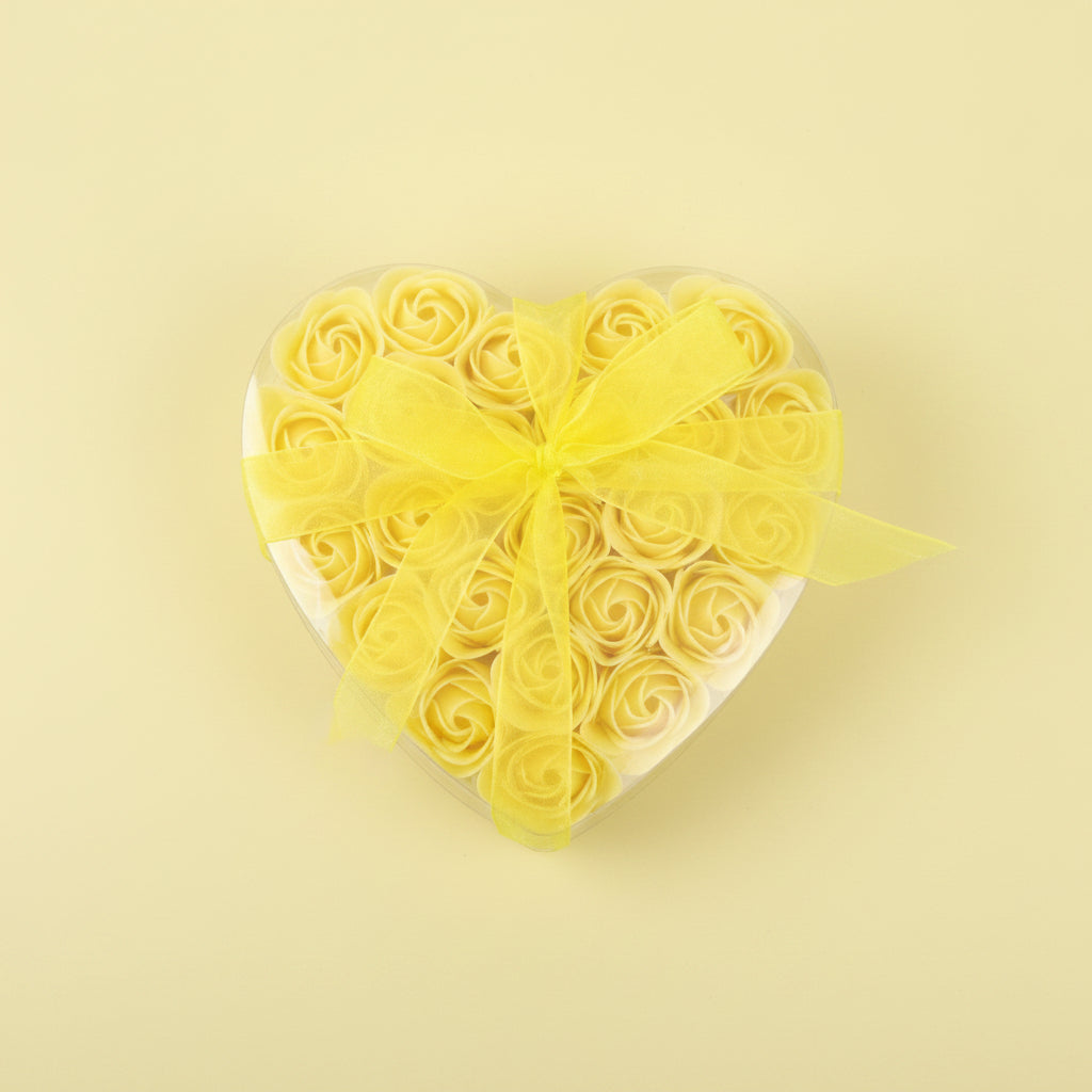 Bouquet of yellow roses with a yellow ribbon on a yellow background